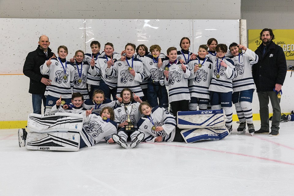 Citizen Photo by James Doyle. The Fort. St. John Flyers pose for a team photo after defeating the PGMHA U13 Tier 2 Cougars by a score of 16-2 on Sunday afternoon in the gold medal game of the Deep Freeze 2021 U13 Tier 2 Rep Hockey Tournament.