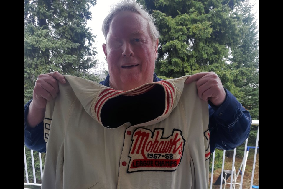 Dave Bellamy holds the coat he wore as a charter member of the Prince George Mohawks senior hockey team.