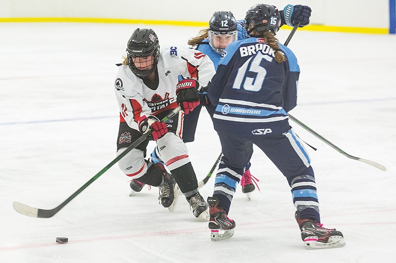 Citizen Photo by James Doyle/Local Journalism Initiative. Northern Capitals forward Jessa Brewer tries to get the puck around Thompson-Okanagan Lakers defenders Meloni Brooks, and Karington Mollin on Sunday morning in Kin 2. The Capitals went on to win the game by a score of 3-2.