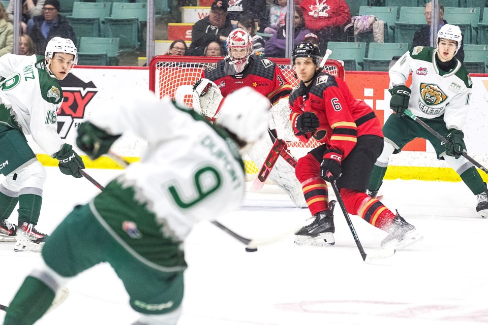 Everett Silvertips defenceman Landon DuPont lets a point shot go at Prince George Cougars goalie Josh Ravensbergen while Cats defenceman Viliam Kmec stands guard during Friday's game at CN Centre.