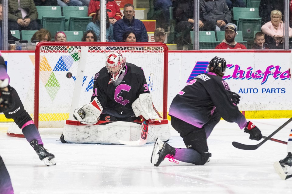 Cougars defenseman Bauer Dumanski goes down to try to block a shot that got through to goalie Josh Ravensbergen during Friday's game against the Kamloops Blazers.