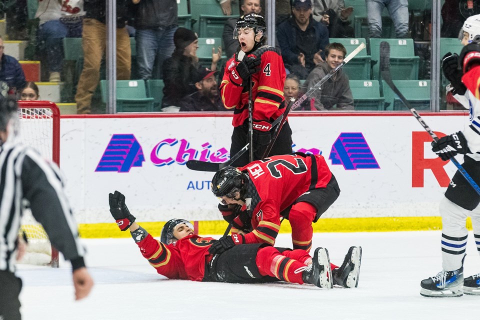 Riley Heidt gets down to ice level to give his linemate Borya Valis a hug after Valis scored what turned out the winning goal 16:08 into the third period in Saturday's 5-3 win over the Wenatchee Wild at a nearly sold-out CN Centre