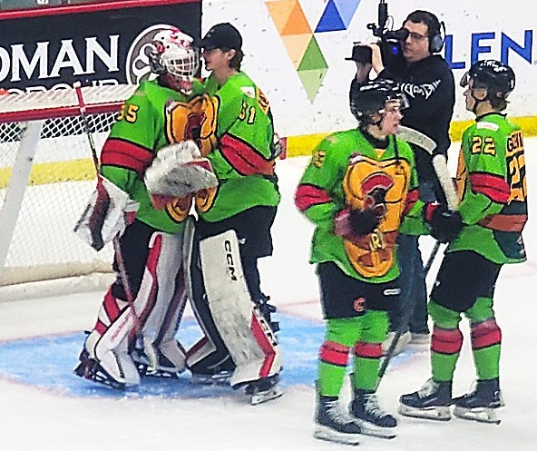 Cougars goalie Cooper Michaluk is congratulated by backup netminder Josh Ravensbergen after  Michaluk stopped all 24 shots in a 3-0 shutout win over the Seattle Thunderbirds Saturday at CN Centre.