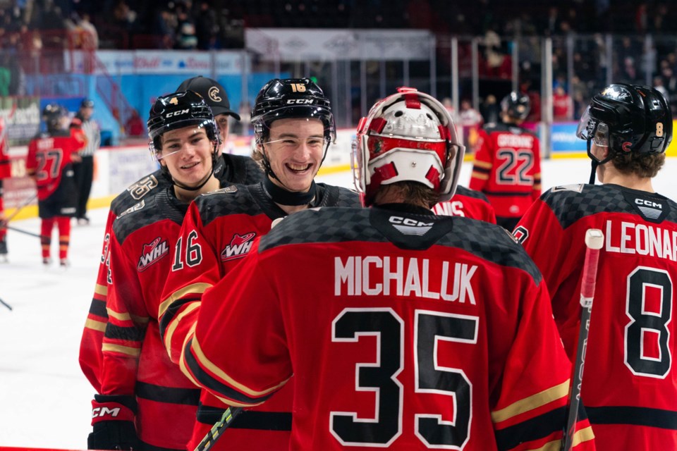 The Prince George Cougars mob goalie Cooper Michaluk after he made 33 saves in a 3-1 win over the Spokane Chiefs, his former team, Saturday in Spokane.