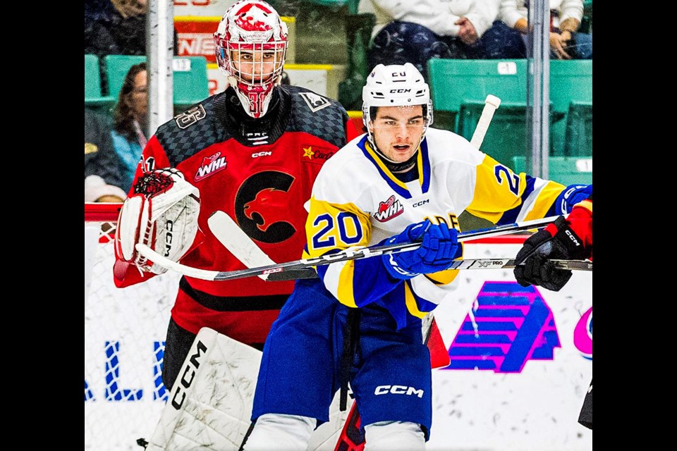 Saskatoon Blades defenceman Tyler Parr tries to obstruct Cougars goalie Josh Ravensbergen's view of the play in front of him in Tuesday's WHL action. Parr scored a sceond-period power-play goal to help the Blades to a 5-4 overtime win in front of a CN Centre crowd of 3,019.