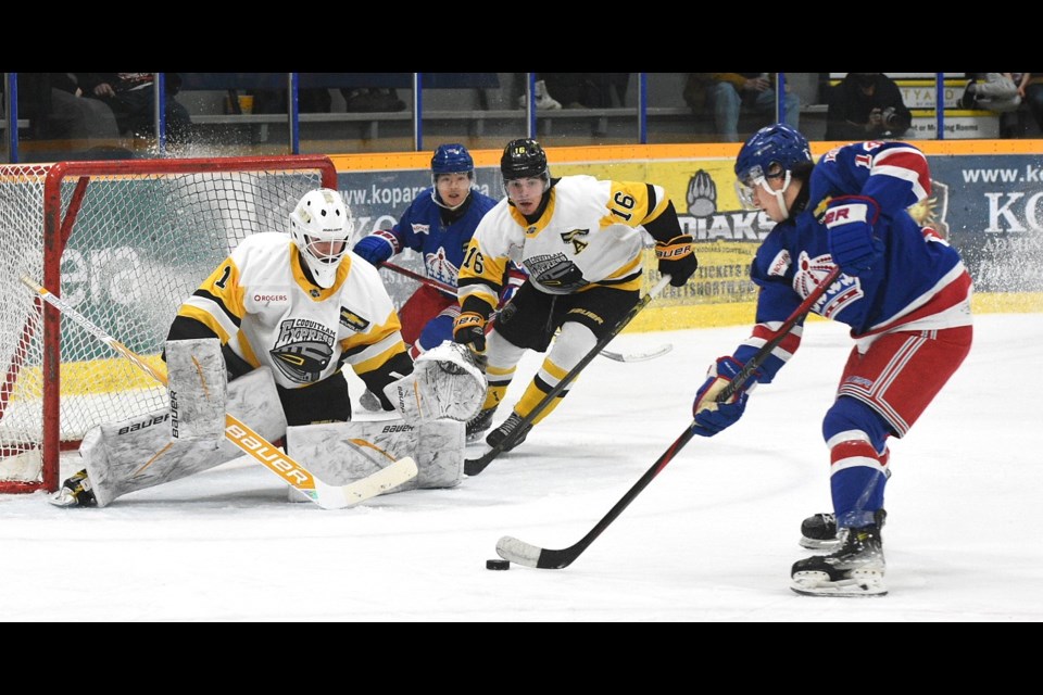 Spruce Kings winger Linden Makow puts on the brakes as he cuts into the slotwiththe puck in front of Coquitlam Express goalie Andrew Ness during Friday's BCHL game at Kopar Memorial Arena.