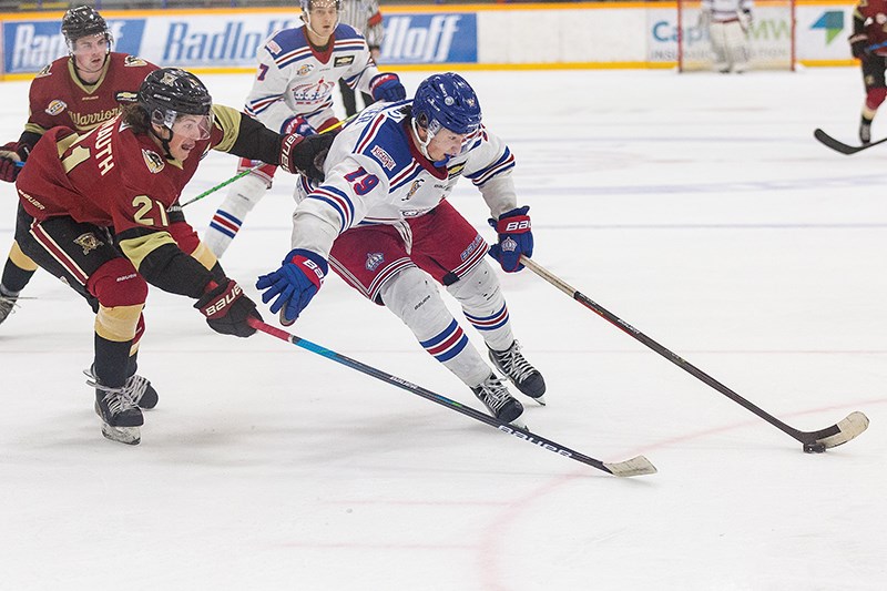 Citizen Photo by James Doyle/Local Journalism Initiative. Prince George Spruce Kings forward Austin Fraser cuts hard to the net against West Kelowna Warriors defender Tyson Jugnauth on Wednesday evening at Rolling Mix Concrete Arena. 