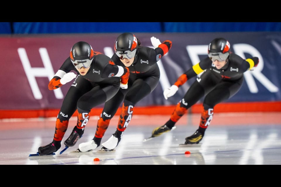 Carolina Hiller of Prince George, right, skates with Ivanie Blondin and Beatrice Lamarche in the ISU World Cup team sprint on their way to the gold medal Sunday in Calgary.