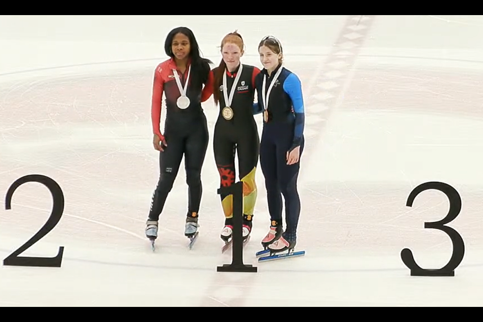 Calla Haaheim of Kelowna, centre, shares her 500-metre gold-medal moment with silver medalist Abbighael Jeune of Quebec, left and bronze medalist Lea Boucher of Quebec at the Canadian Junior Open short track speed skating championships Saturday at Kin 1.