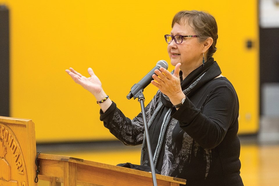 Citizen Photo by James Doyle. Lheidli T'enneh elder Darlene McIntosh gives a traditional welcome on Wednesday afternoon at Duchess Park gymnasium during a banner raising ceremony to celebrate the Duchess Park Condors senior boys volleyball team's recent provincial volleyball championship.