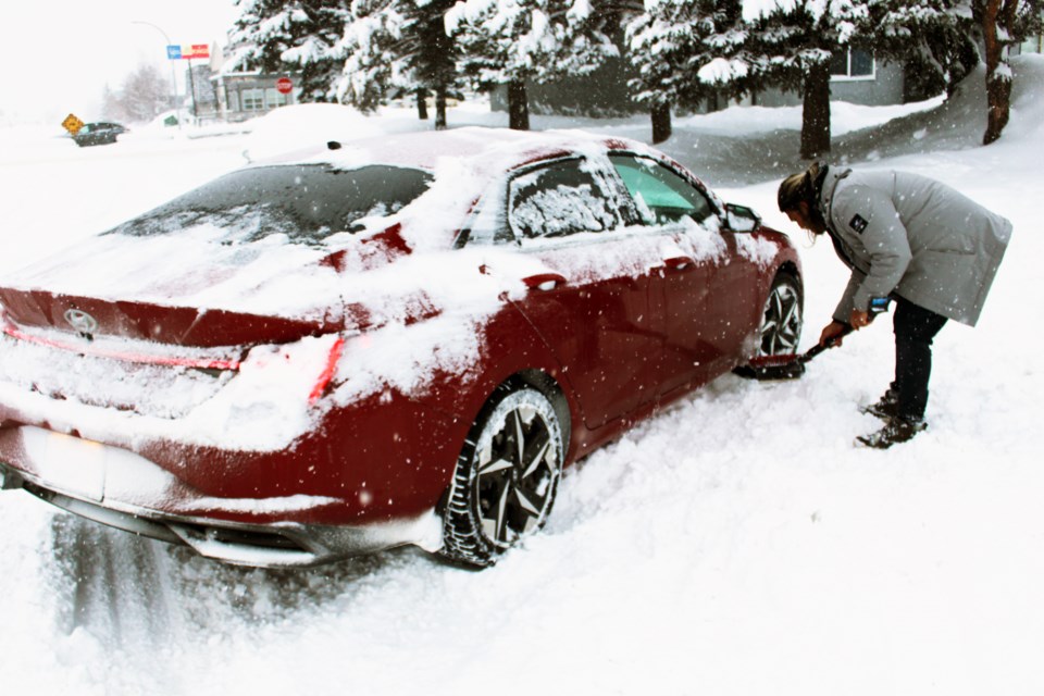 snow-man-digging-stuck-car-feb-1-2023