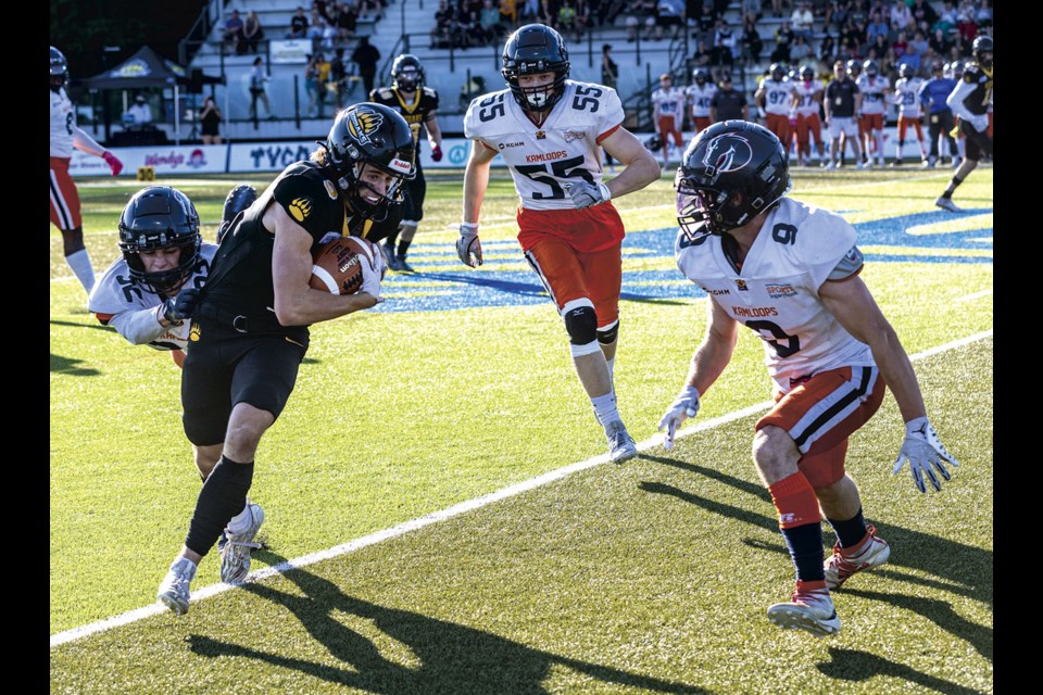 Prince George Kodiaks receiver Carson Briere keeps running forward as the Kamloops Broncos defense closes in during Saturday's 43- 27 defeat at Masich Place Stadium.