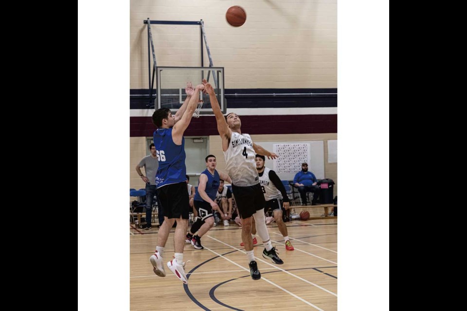 Isaiah Pryce of the PG Ravens launches a shot over the outstretched arm of Similkameen Jessi Vissia during their game Saturday in the Lheidli Classic Basketball Tournament at John McInnis.