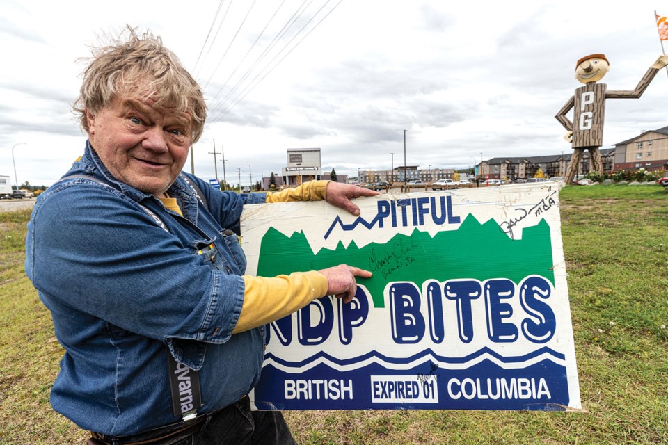 Mark Makela points out the signature of former BC Premier Christy Clark on his anti-NDP election sign in front of Mr. PG.