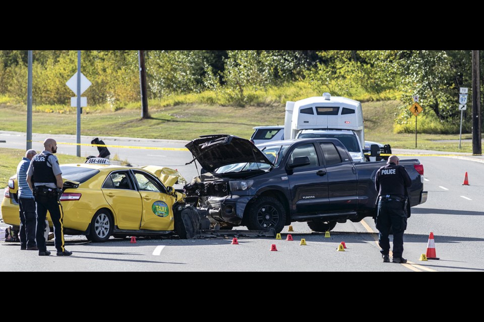 RCMP work at the scene of a collision on Massey Drive involving a taxi and a pickup truck Sunday afternoon. First responders were called to the scene at 2:37 p.m.