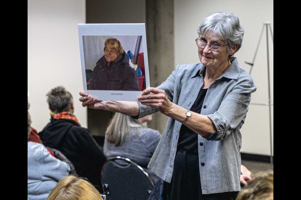 Miracle theatre producer Anne Laughlin holds a picture of senior Judy Joudrey, who was evicted from her home when increases meant she could cover her rent, at the kick-off the Miracle Theatre project scheduled to run March 17 to April 24, 2025 at Artspace.