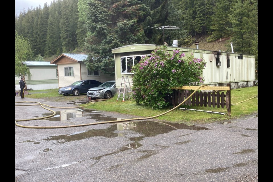 Firefighters work at the scene of a mobile home fire in Prince George, B.C. on Monday, June 3, 2024.