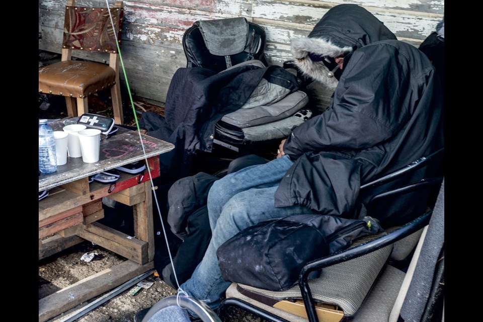 A person, who could be seen moving and breathing, waits in the "coffee area" outside the AWAC warming shelter on Friday, Oct. 11. 