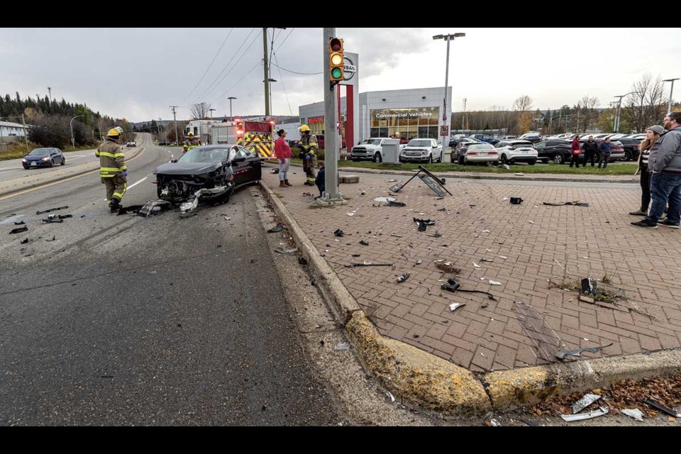 Emergency crews work at the scene of a two-vehicle collision at the intersection of 20th Avenue and Highway 16 west at about 4:20 p.m. Wednesday, Oct. 23, 2024. No life-threatening injuries were sustained, though the driver of the Honda Civic was attended to by paramedics.