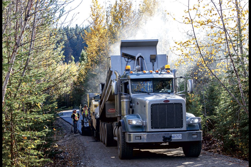 A Terus road crew lays asphalt on the Northern Lights trail at Otway Nordic Centre Friday, Oct. 11 as part of 2.6 kilometres of trails being paved at the world class cross country skiing and biathlon facility.