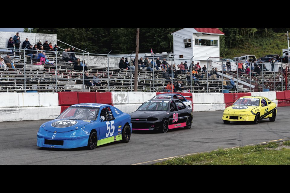 Davis Cooper #55 leads Savanna Boudreau into turn 1 during Mini Stock Heat action Friday night at PGARA.