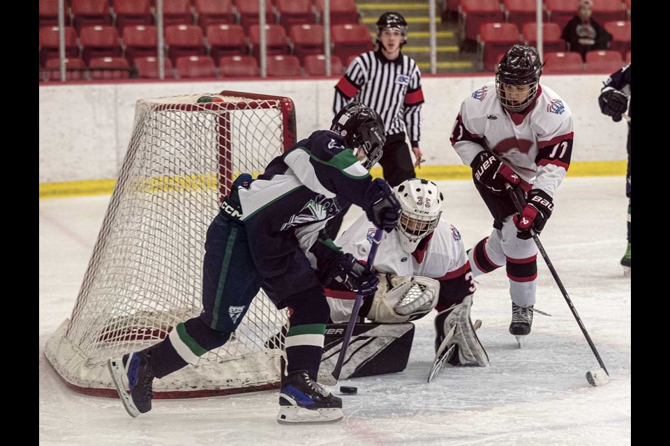 A U13 Smithers Storm player has his shot around the post of the goal blocked by the Prince George U13 Cougars goalie Friday evening at Kin 1 during the PGMHA U13 Tournament taking place over the weekend.