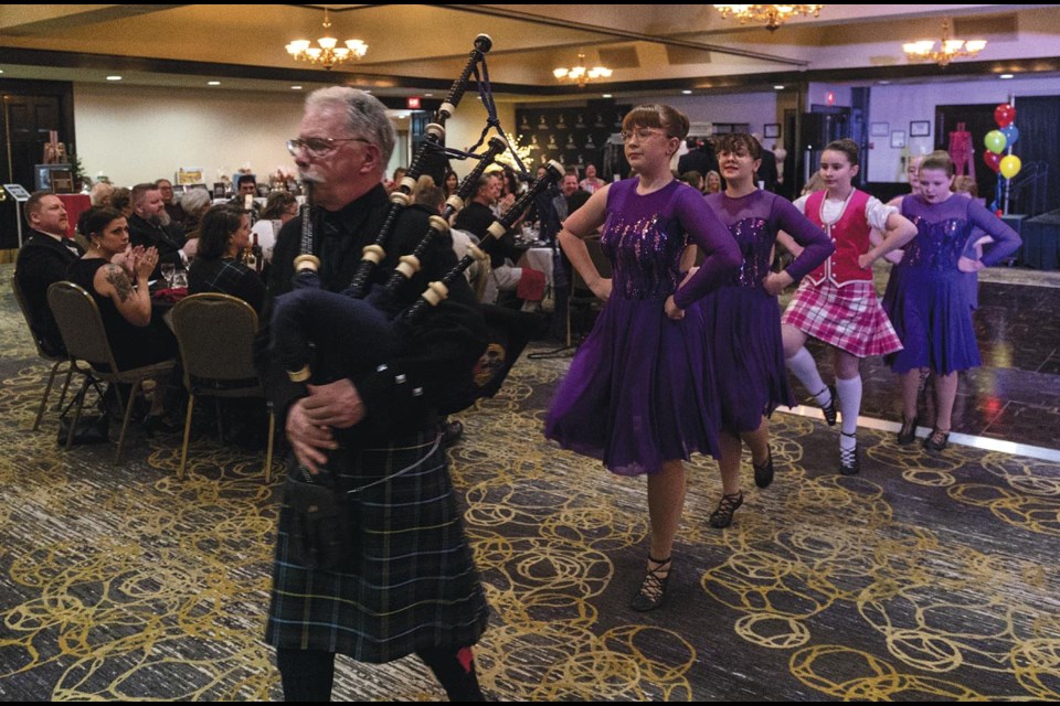 Piper Ian McInnis leads dancers from Excalibur Theatre Arts from the room after they performed highland dances at the PGSO Robbie Burns Dinner on Saturday, Jan. 25, 2025 at the Coast Inn of the North in Prince George, BC.