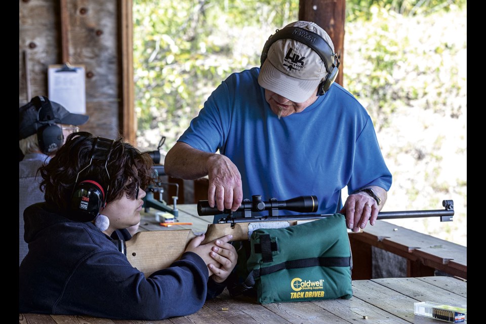 Jeremy Campbell explains to Rayae Morrison, 14, how to properly load and fire the 1956 Brno No. 4 .22 calibre rifle as he attends the Prince George Rod and Gun Club open house at the Hartman Road range Sunday. Campbell, who has more than 30 years experience training young biathlon athletes, said he was quite impressed with Morrison's efforts.