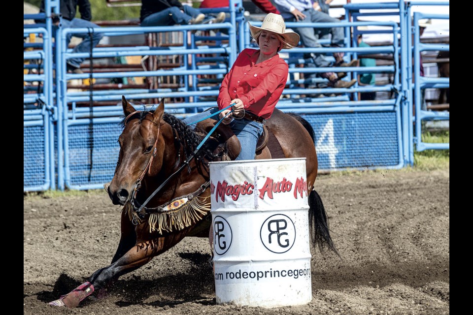 Charlee Farmer coaxes her horse into a tight turn around the final barrel as she posts a time of 16.738 seconds Sunday at the Rodeo Prince George at the Prince George exhibition grounds Sunday. 