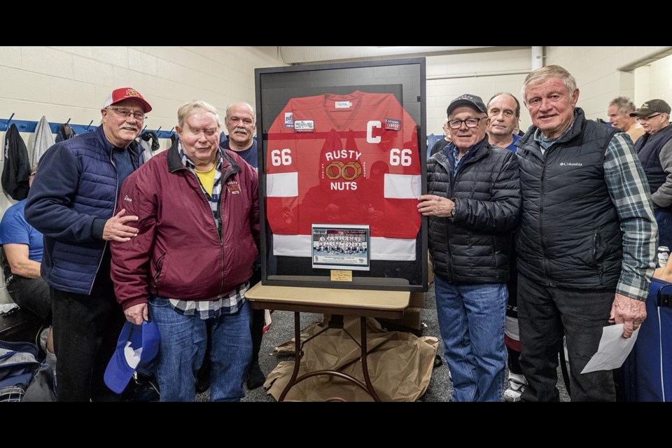 Dave Bellamy, second from left, was one of the founding members of the Prince George Rusty Nuts when they starting playing oldtimers hockey tournaments in 1986. The team executive, from left, Norm Schmitz, Gord Flewelling, Neil Bilodeau, Wes Zapotichny and Charlie Freeman, presented Bellamy with his framed jersey following their game Friday (Dec. 20) at Kin 1.