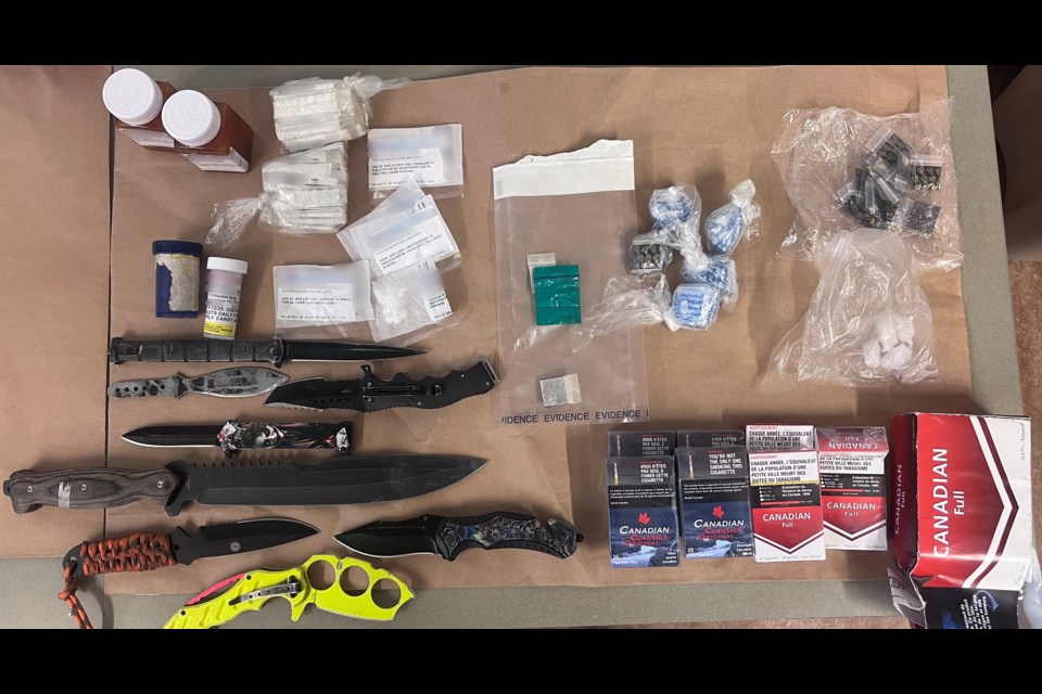 Prince George RCMP seized weapons, suspected drugs and counterfeit cigarettes on Tuesday, Feb. 11, 2025.