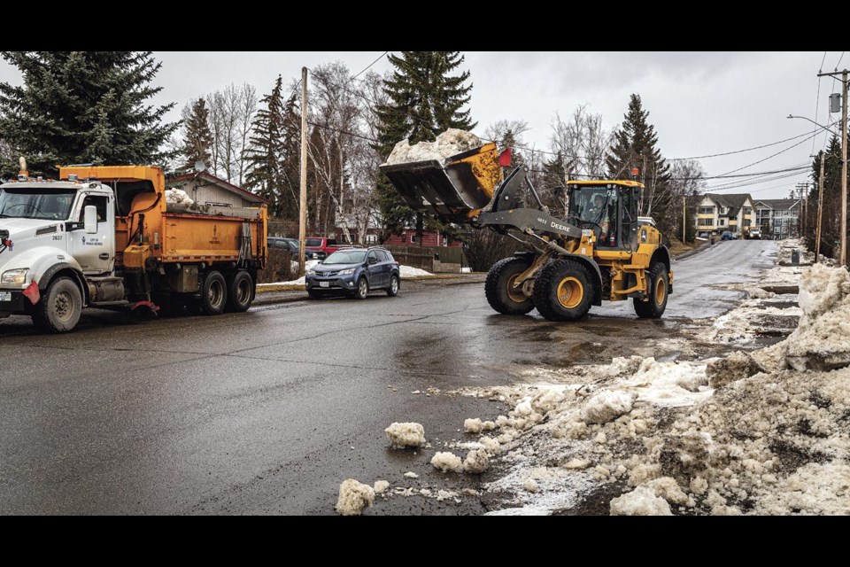 City crews clean-up some of the snow built up along Pine Street Wednesday March 5, hoping to get prepared for street cleaning to start in the next few weeks.