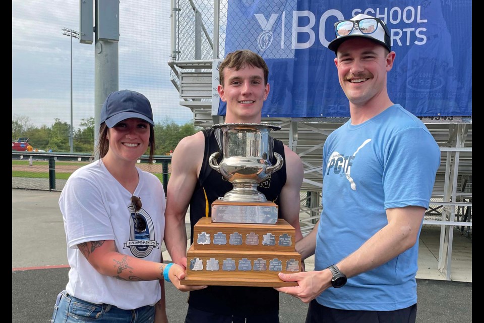 Adam Sieben of Duchess Park Secondary School poses with PGTFC coaches Lauren Matheson and Ross Browne after he won the senior boys 100m sprint at the B.C. School Sports track and field championships in Nanaimo.