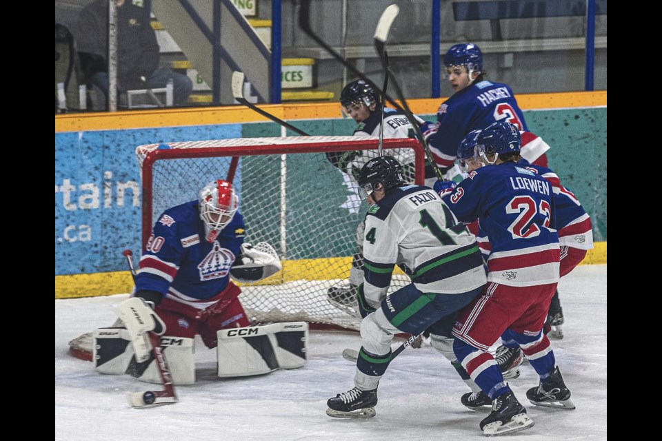 Spruce Kings goalie Dylan Johnson blocks a shot as Eagles centre Massimo Fazio follows the shot into the crease Wednesday at Kopar Memorial Arena.