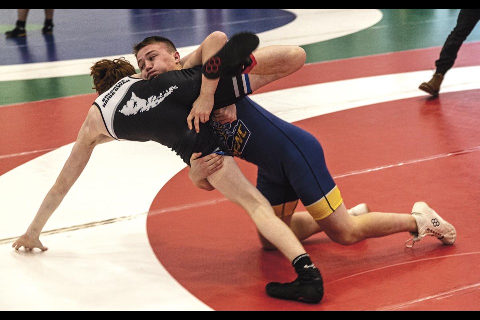 Hayden Devaud of Shas Ti Kelly Road Secondary School (STKR) tries to turn Payden Ismay of Gidg̱alang Kuuyas Naay Secondary School (GKNS) during their 53-57kg match at the 43rd annual Shas Ti Kelly Road Wrestling Tournament Saturday.