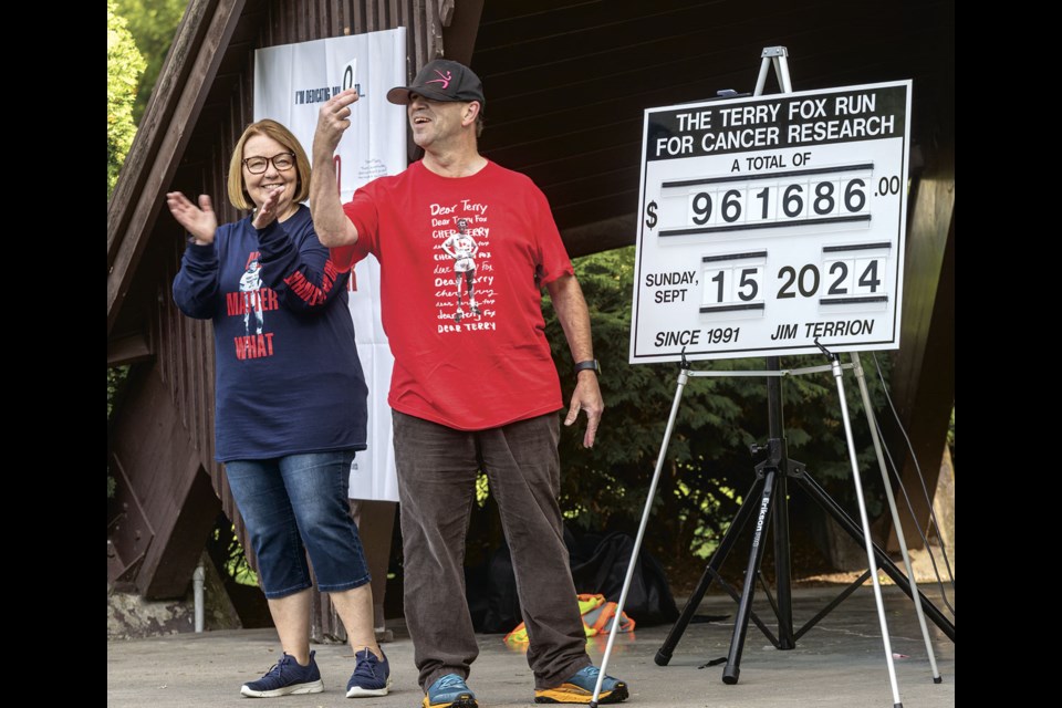 Jim Terrion, who has raised $961,686 for cancer research since 1991, holds up the final zero to finish his total on the sign onstage at the Lheidli T'enneh Memorial Park bandshell prior to the start of this years run Sunday. Terrion is hoping he'll be able to reach his goal of $1 million before the end of 2024.