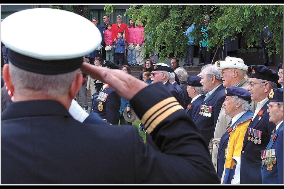 June 7, 2004: Veterans and members of the public gather at the Cenotaph the day before  to honour the 60th anniversary of D-Day, the day Canadian and other Allied troops stormed the beaches of Normandy, France and helped bring about the end of the Second World War. The ceremony featured an expression of thanks from Jerry DeWit, who was a boy in the Netherlands when the country was liberated from the Nazis by Canadians.