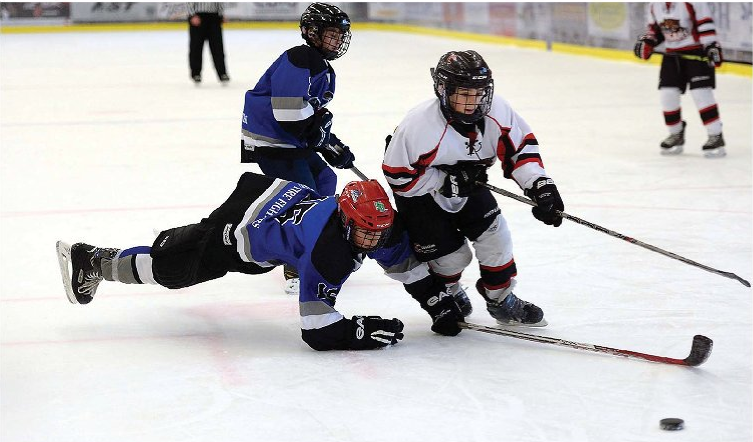 Dec. 12, 2015: Ayden Baldo of the Kitimat Winterhawks dives to get to the puck before Zachary Fillion of the Premium Truck and Trailer Cougars during a Friday game at the Up the Creek Garment Company Peewee Tier 2 tournament. The Cougars went on to am 8-2 win. Brendan Gaboury scored twice, Nic Braaten had a goal and three assists and Fillion, Jacob Ross, Logan Jones, Jerome Erickson and Gavin Vaillancourt also scored for the Cougars.