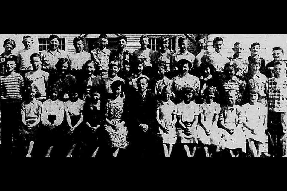 The Grade 6 class of Connaught Elementary School, which had been lost to fire, join teacher Ron Brent for a photo. Front row (left to right) are Sandra Jack, Mary Lawyer, Lynda Nash, Maye Bird, Lyla Mahon, Mr. Brent, Joan Clements, Doreen Balaski, Alice Griffin, Naomi Esau and Mavis Owens. Middle row: Martin Blackburn, Michael Watt, Carol Bater, Cynthia Foxcroft, Bonnie Baines, Grace Bjarmnson, Teresa Elgert, Lorraine Solnik, Jean Mounkley, Carl Loland and Garry Wray. Back row: Eric Allen, Donald Hanson, Harold Wade, Donale Krenn, John Kennedy, Fred Ceal, Kevin Smale, Laurie Gray, Harland Viberg, Buddy Shaw, Keith White, Keith Almgren, Leslie Bricker and Gary Dinsmore. Missing are Sharlene Trombley, Lynne Nicol and Zelma Lemp. 
