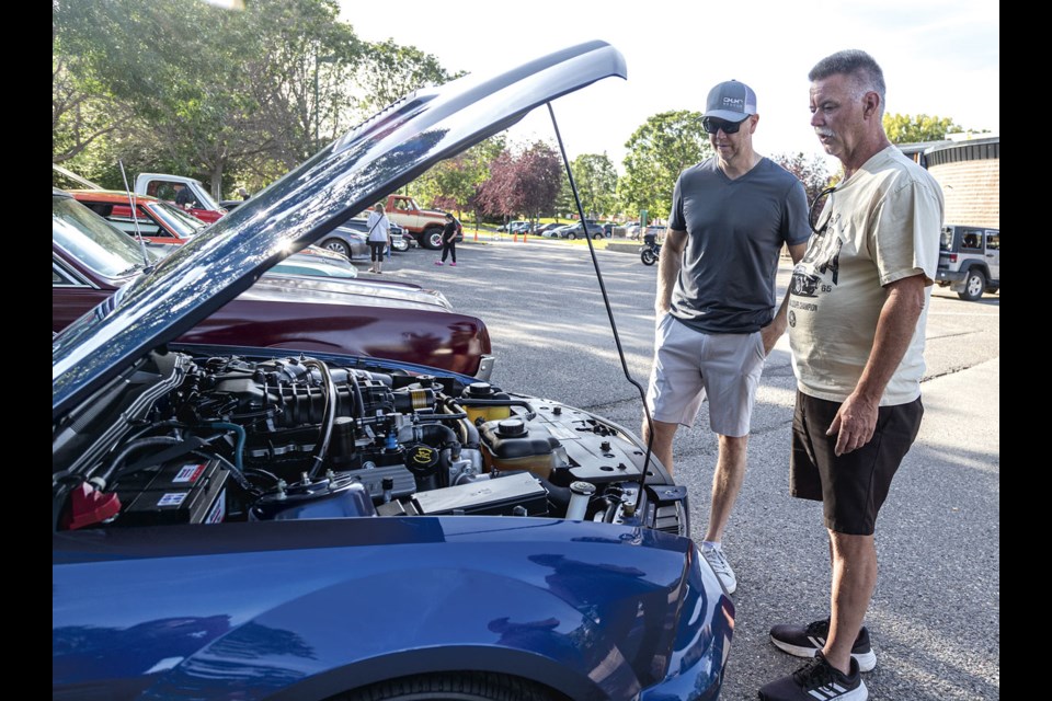 Jeff Shaw and Al Beeson admire Shaw's 630HP 2008 Shelby GT500 as they take part in Thursday in the Park at Lheidli T'enneh Memorial Park, which features cars from local car clubs, food available from the Exploration Place take-out window and the Little Prince taking riders around the park until 8 p.m. each week.