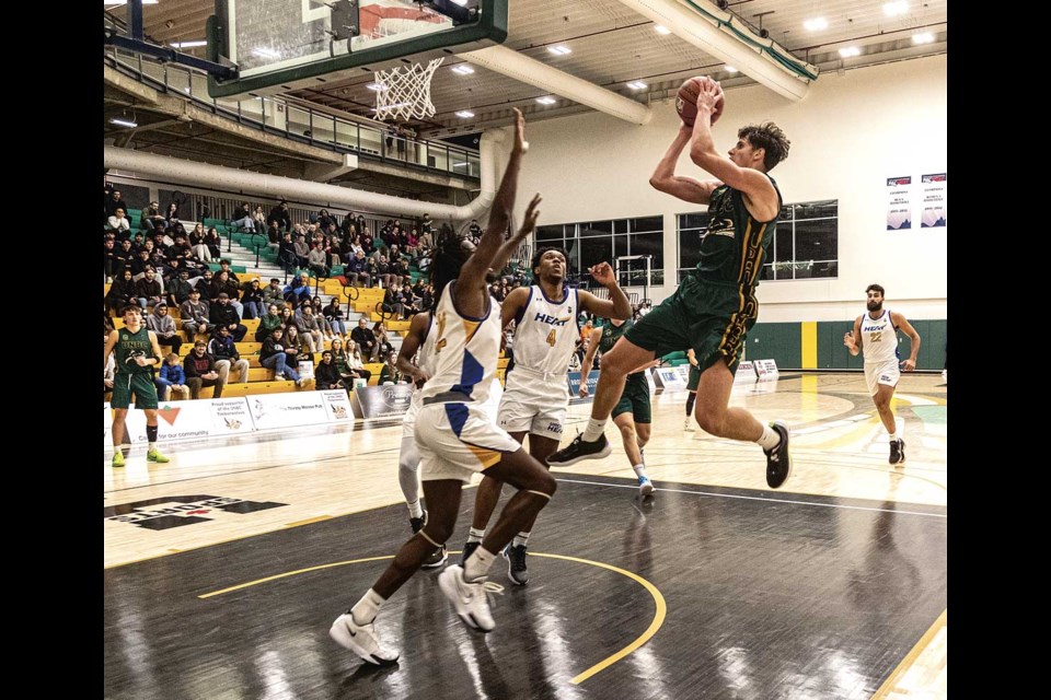 UNBC Timberwolves Evgeny Baukin leaps across the key during a 84-74 loss Friday to UBC-Okanagan Heat at the UNBC Northern Sports Centre. The TWolves won trhe rematch Saturday 83-72