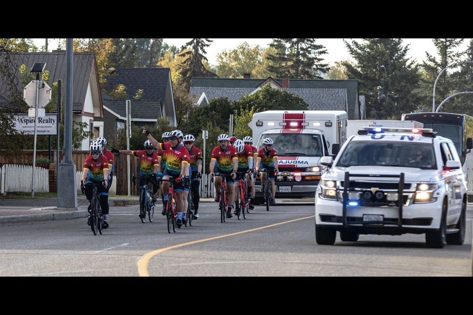 The riders of the Cops for Cancer Tour De North make their way along Fifth Avenue Tuesday as they approach their destination for Day 5 of their seven-day, 850-kilometre ride from Dawson Creek to Williams Lake to raise funds for childhood cancer research.