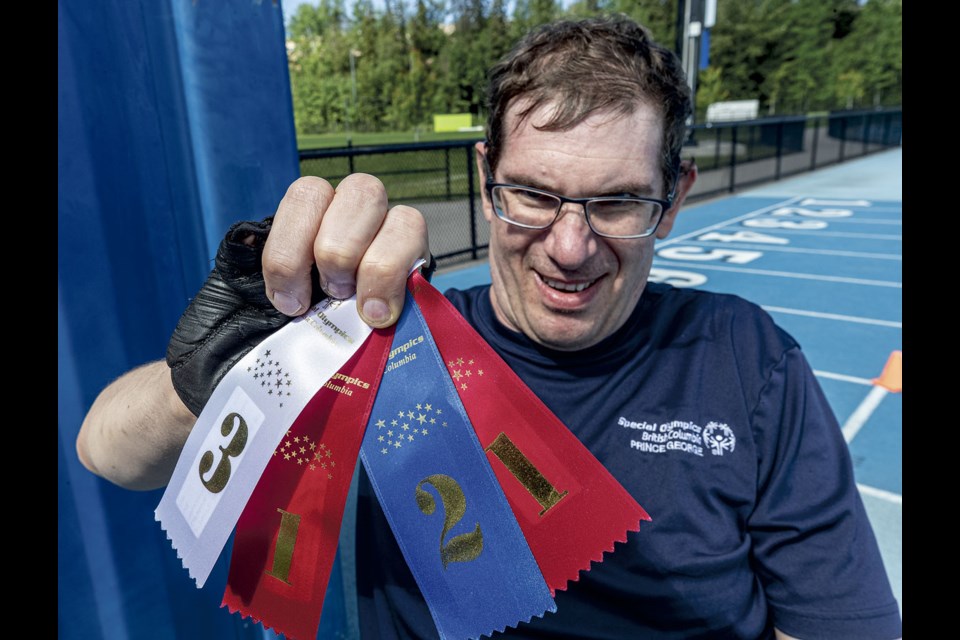 Tyler LeFebvre holds up the ribbons he won at the B.C. Region 7&8 qualifier in Smithers on June 29. LeFebvre took first place in the 25-metre wheelchair event, 30-metre wheelchair slalom, second in mini javelin and third in shot put.