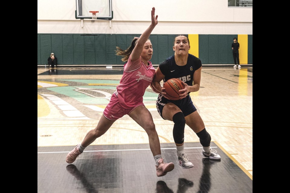 UBC Thunderbirds forward Mona Berlitz drives for the basket as UNBC Timberwolves guard Sophia Fuller tries to block her Friday Feb 14 at Brownridge Court.