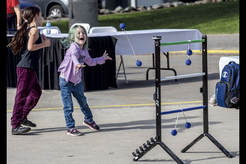 Four-year-old Alice Lang screams excitedly while playing Ladder Ball with Wynona Lang, 7, during the Volunteer Appreciation Event put on by the city Wednesday at Canada Games Plaza.