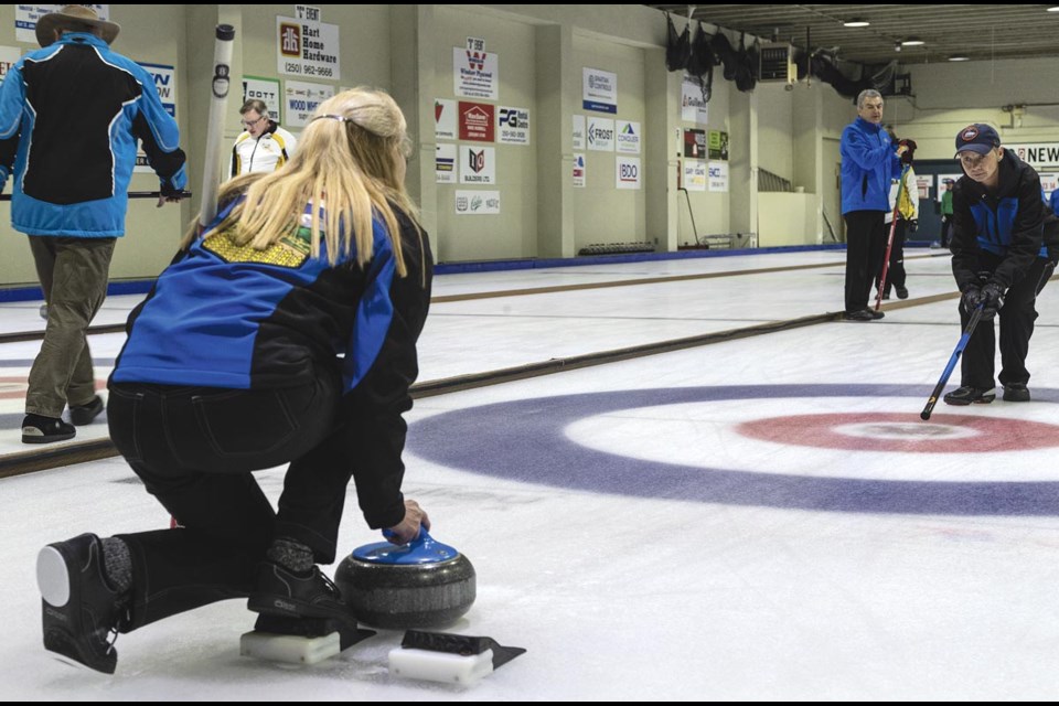 Team Alberta One skip Natalie Morin taps her broom on the ice to let lead Lori Hysert know where to aim her rock in their final match against Team BC One in the Western Blind Curling Championships Sunday, March 22, 2025.