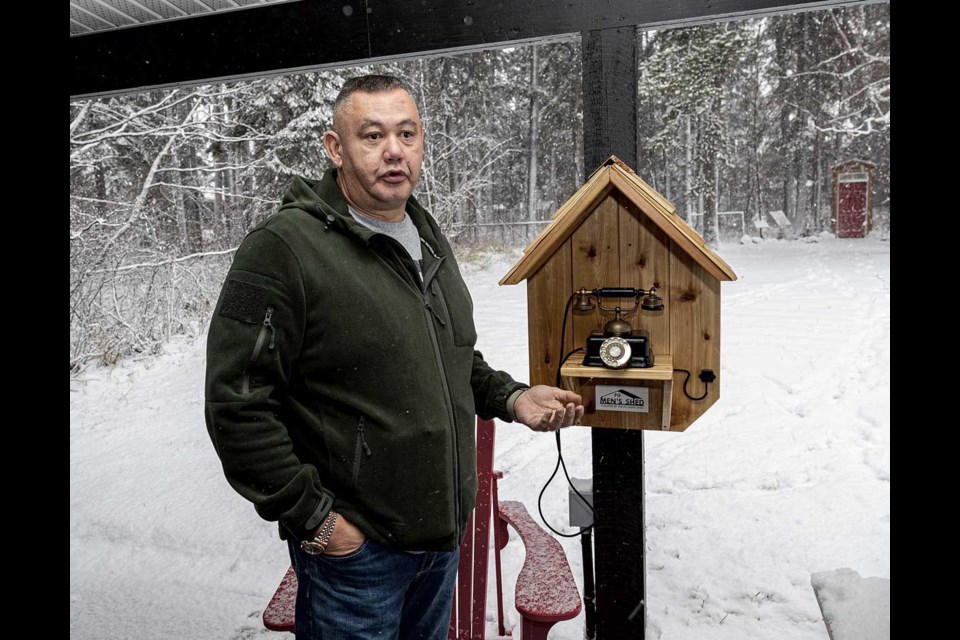 PG Men's Shed member Jason Gillis explains Saturday how the Wind Phone the group built and installed outside the Hospice Rec Room will be available for anyone to stop by and use it.