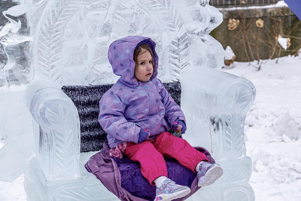 Arielle, 3, poses on an ice throne for her mom's pictures during Downtown Winterfest on Saturday, Feb. 15, 2025 at Veteran's Square.