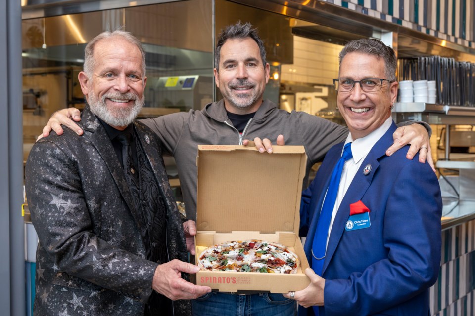 From left, Gary Michael Hamm of Magicians on Mission, Spinato's Pizzeria CEO Anthony Spinato and Chris Rose, founder of Magicians on Mission, with the new Stay Golden Pizza. A portion of proceeds will benefit the Phoenix-based nonprofit which recruits the best magicians from North America to boost the morale and emotional health of American service members deployed overseas.