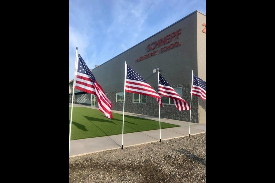 American flags in front of Schnepf Elementary School in Queen Creek.